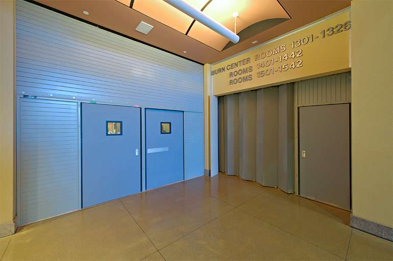 Side Acting Fire Rated Accordion Fire Door Providing Elevator Separation within an I-2 Occupancy